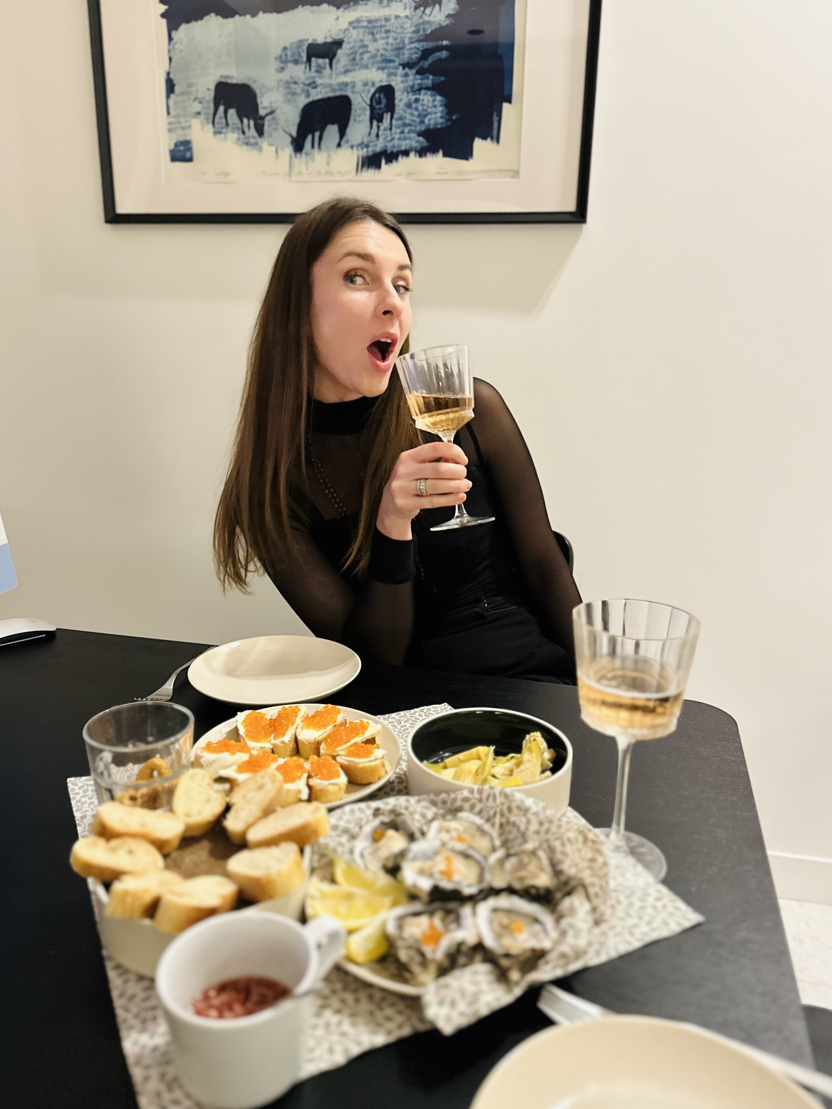 Guest enjoying Mediterranean appetizers and wine